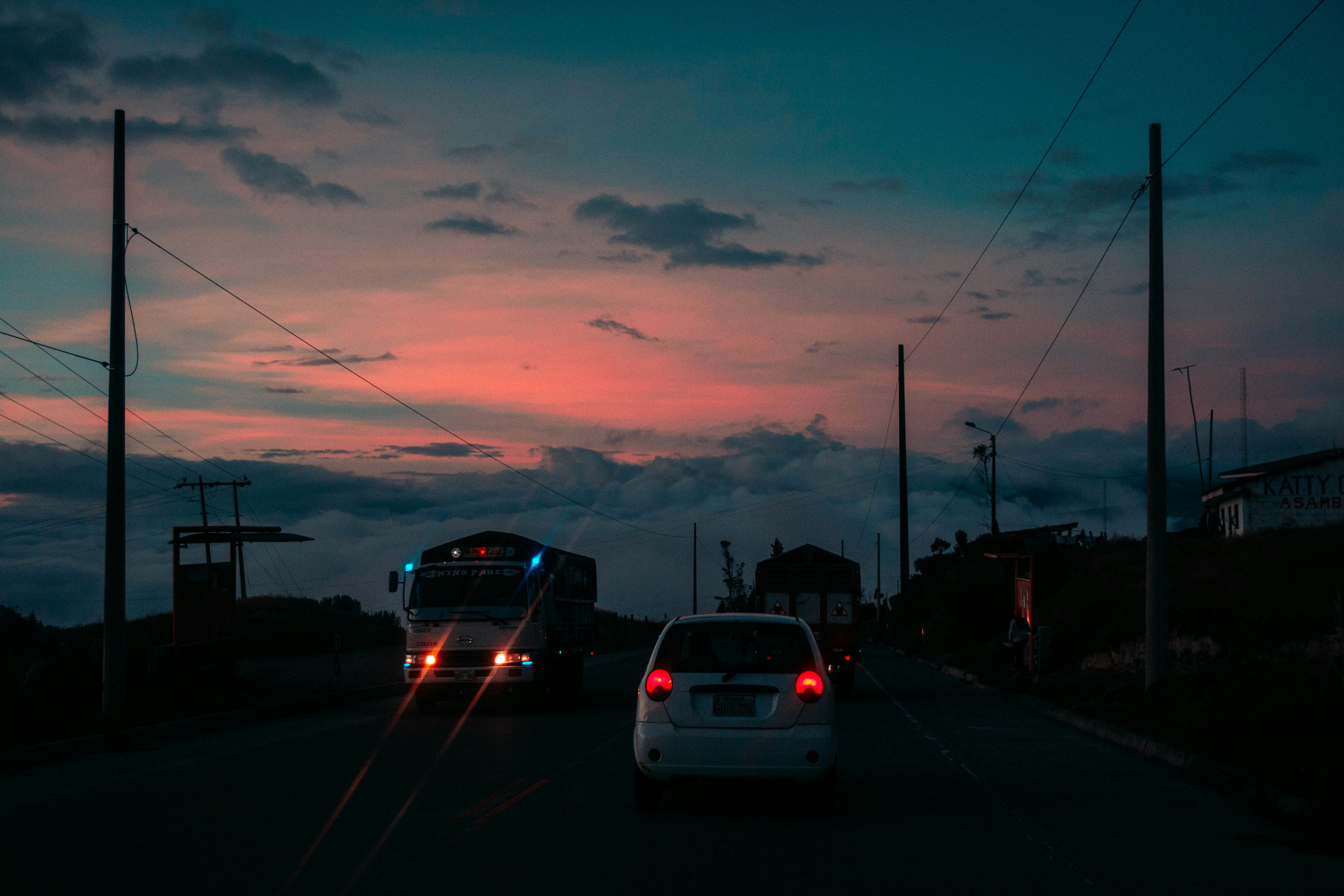 white suv on road during sunset