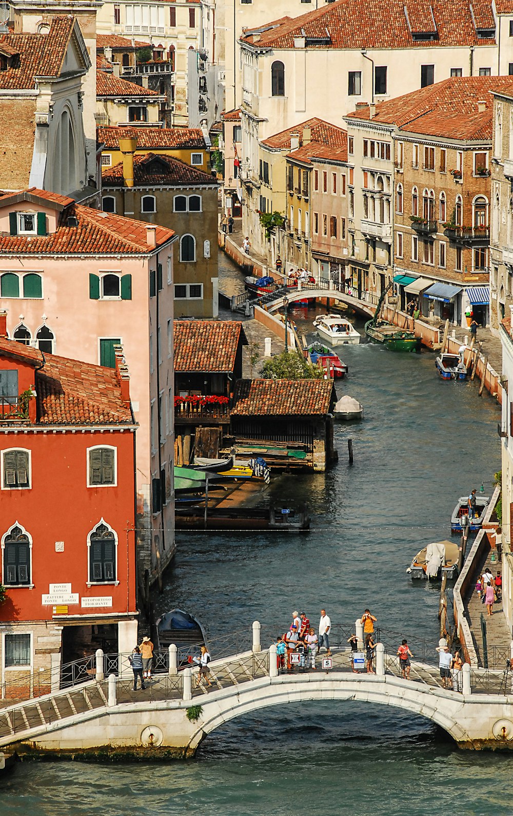 people on boat on river near buildings during daytime