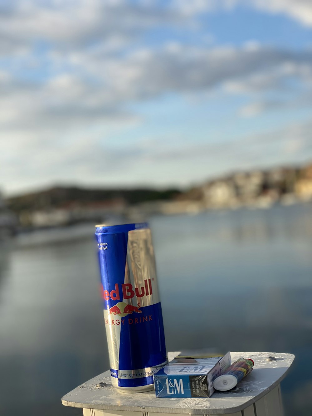 red bull energy drink can on white wooden table