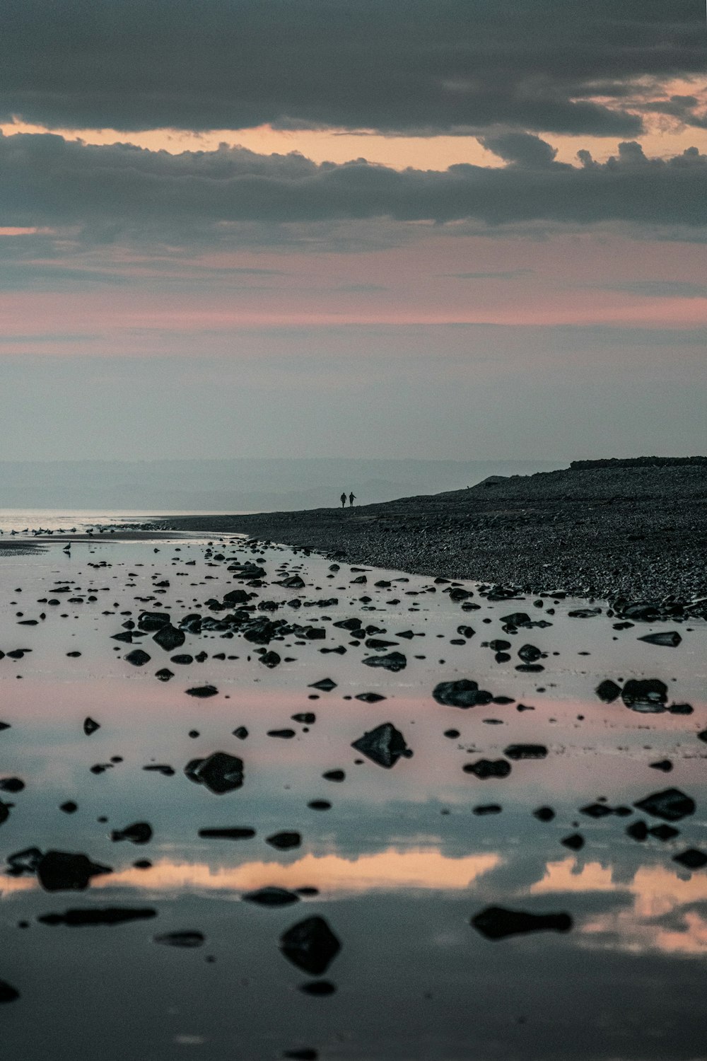 black and white stones on seashore during daytime