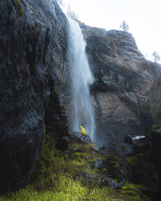 waterfalls on rocky mountain during daytime in Kelowna Canada