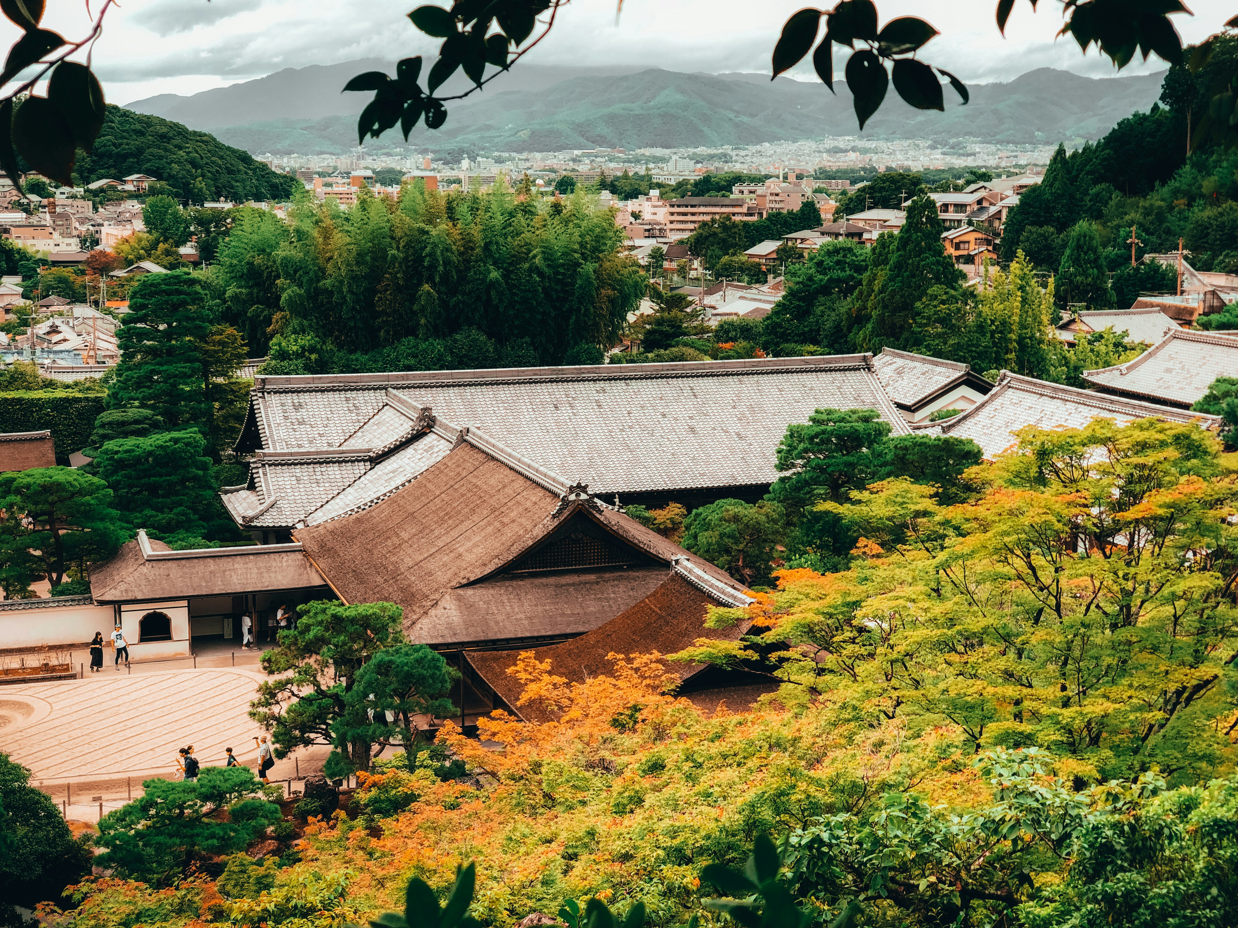 brown and white house near green trees during daytime, kyoto, Japan