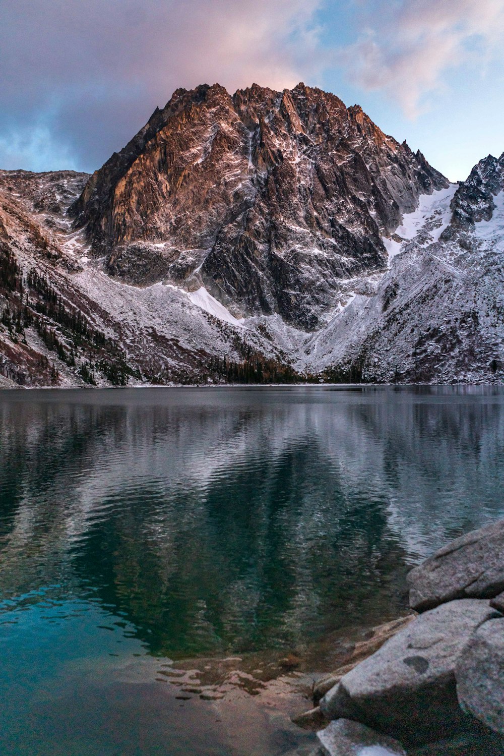 lake near mountain during daytime