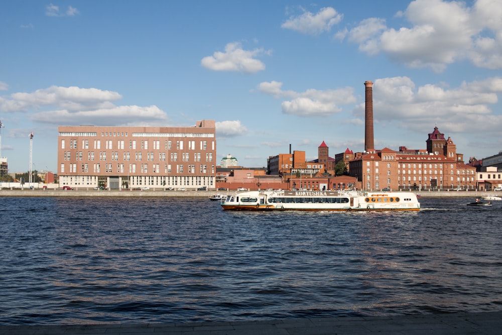 a large body of water next to a large brick building