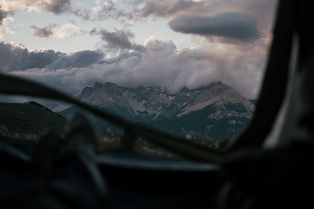 snow covered mountains under cloudy sky during daytime