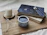 A cozy nook with a latte, an open dot-grid journal, and soft floral accents on a wooden table.