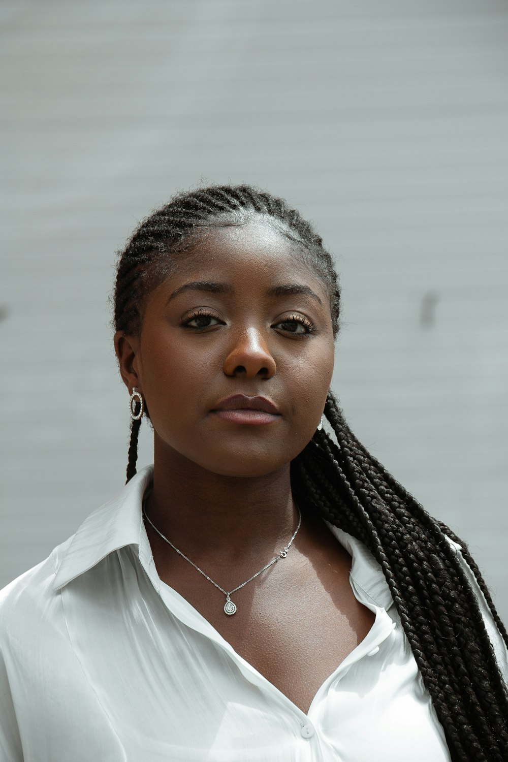 woman in white shirt wearing silver necklace