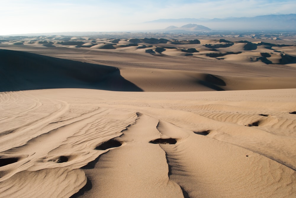 brown sand field during daytime