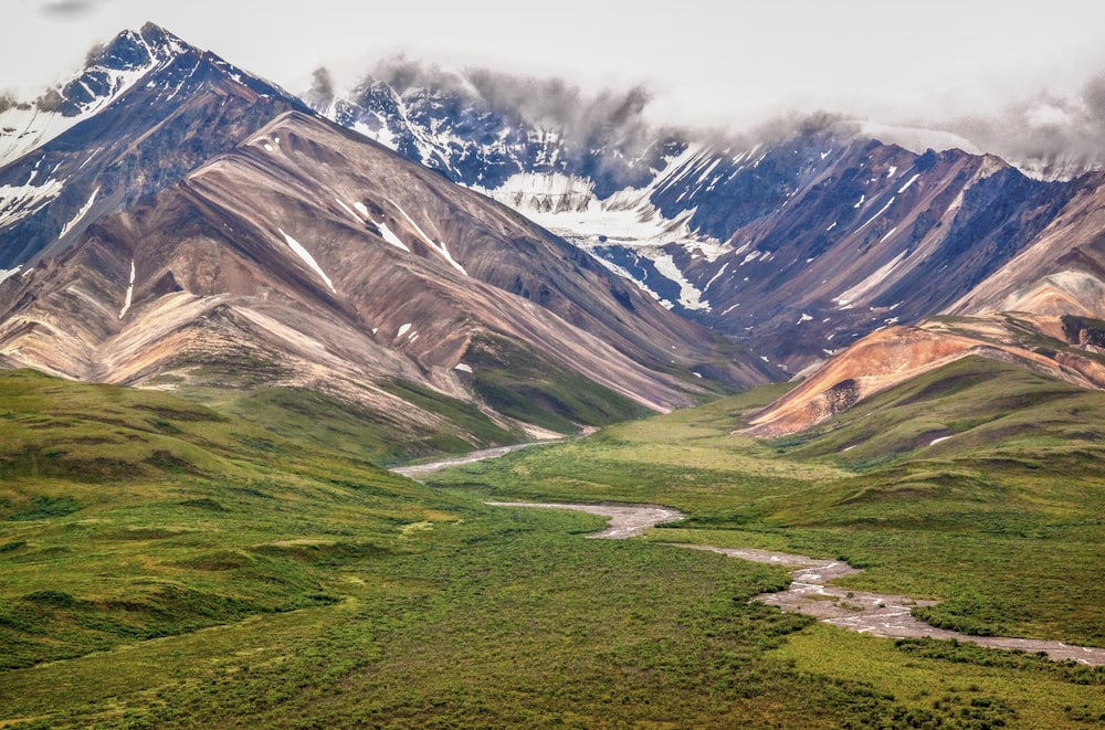 green and brown mountains under white sky during daytime