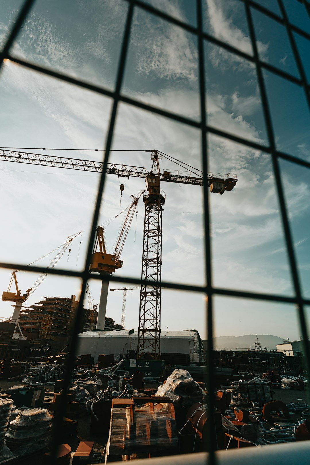 yellow crane under blue sky during daytime