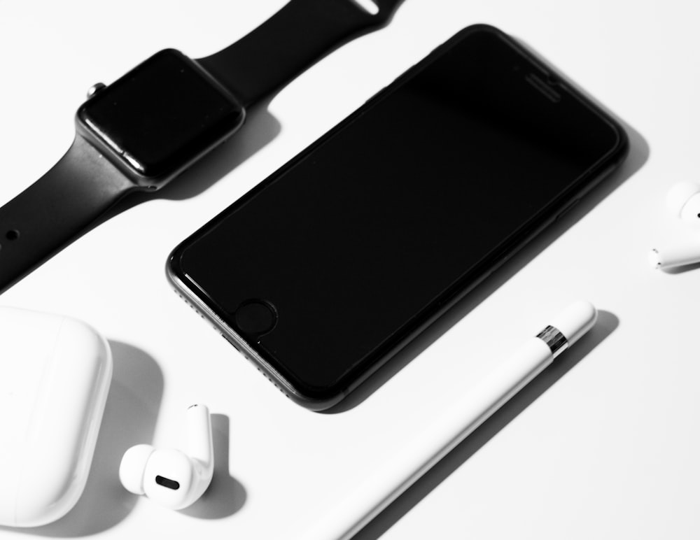 white apple earpods beside space gray iphone 6
