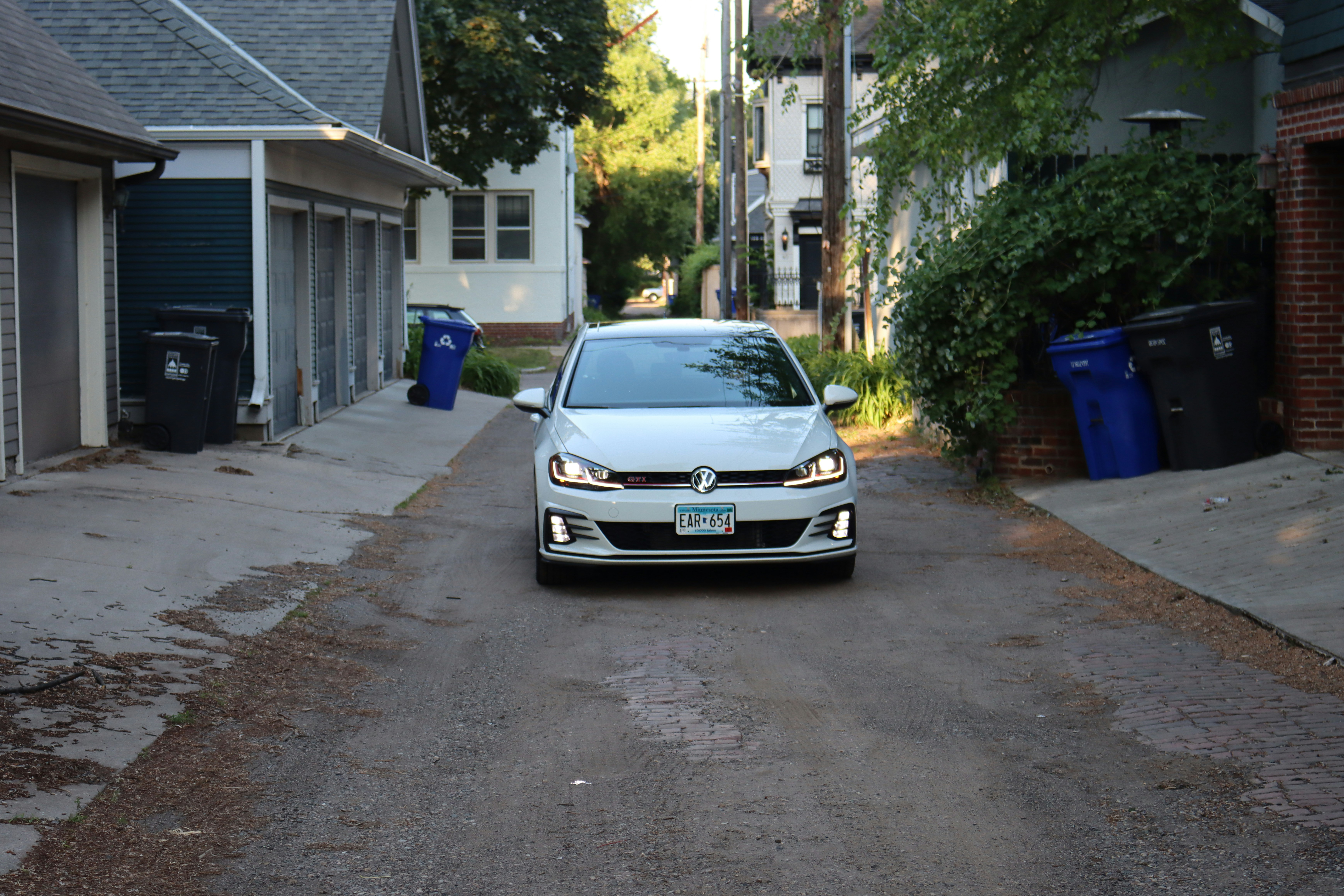 Electric vehicle parked in a driveway highlighting its tires and wheels