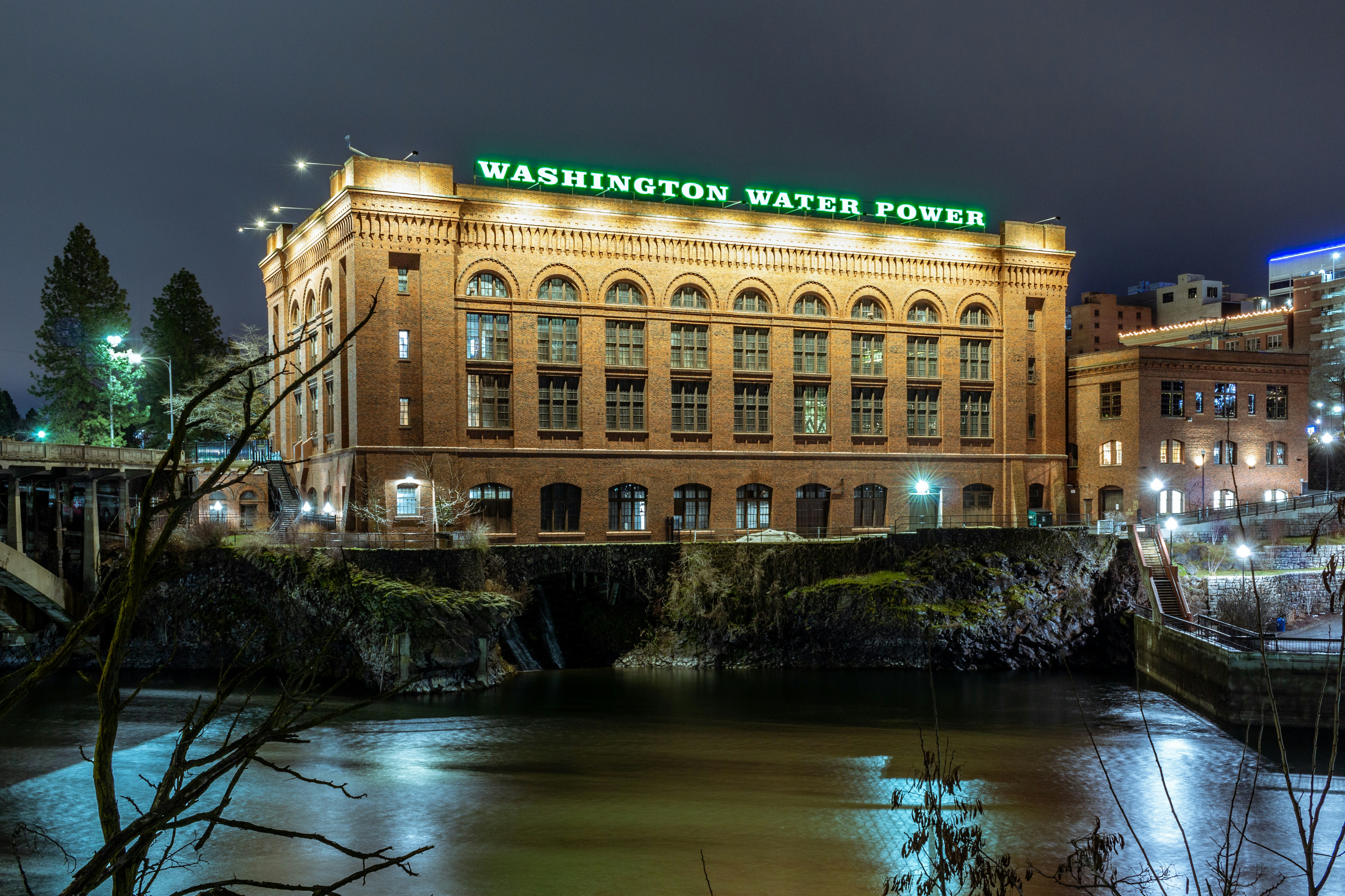 brown concrete building near river during night time, The Washington Water Power Building at night in Spokane WA  