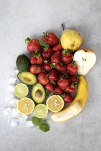 strawberries and bananas on white table