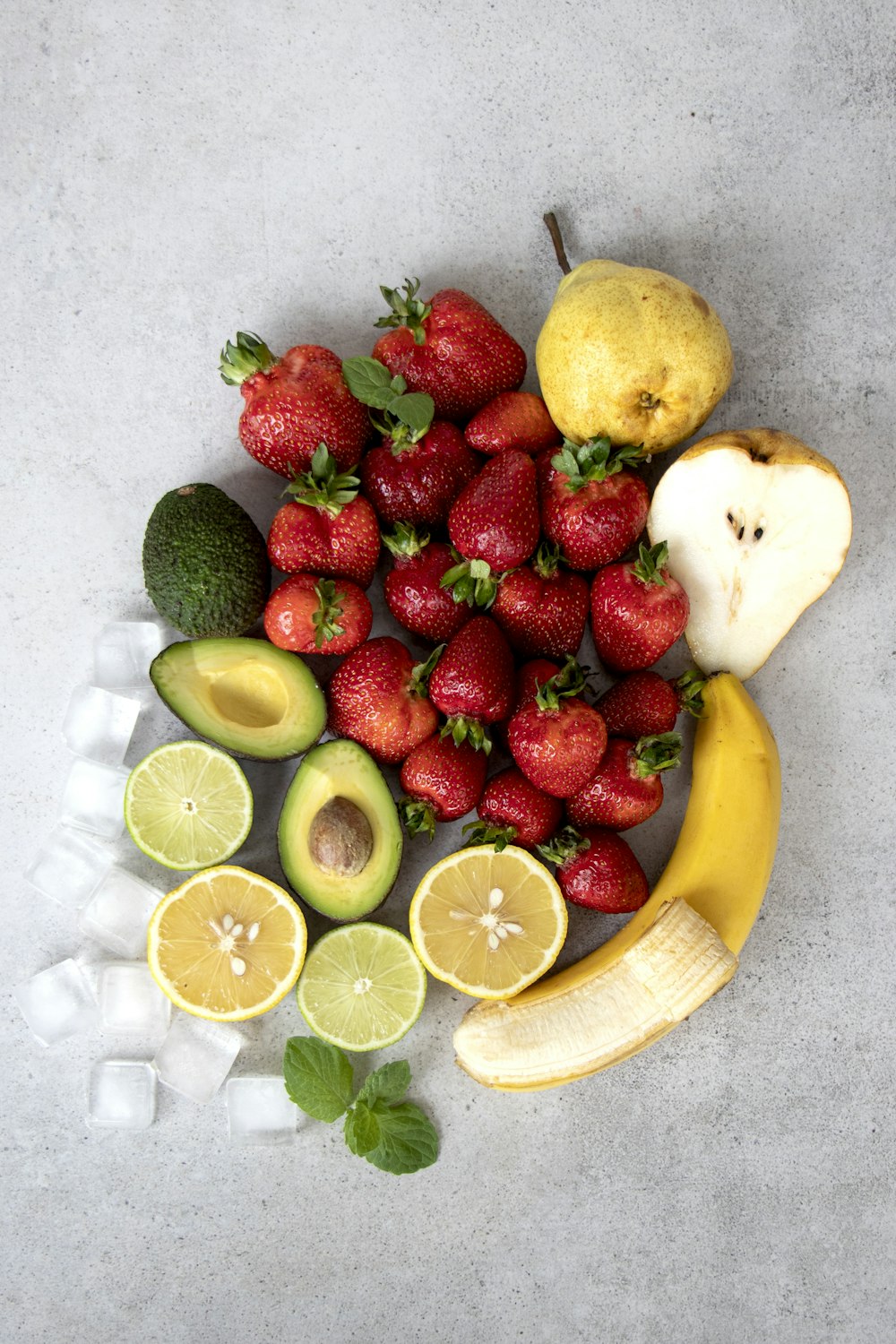 strawberries and bananas on white table