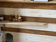 Rustic wooden shelf displaying charming home accessories with heart motifs.