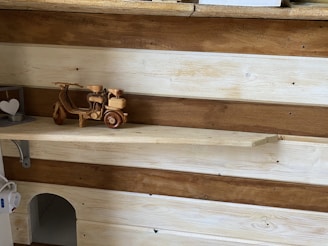 Rustic wooden shelf displaying charming home accessories with heart motifs.