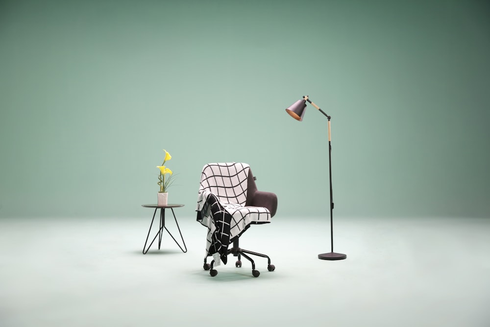 man in black and white checkered dress shirt sitting on black chair