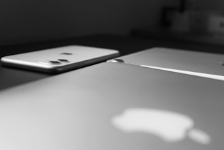 Close-up of modern electronic devices arranged on a wooden table.