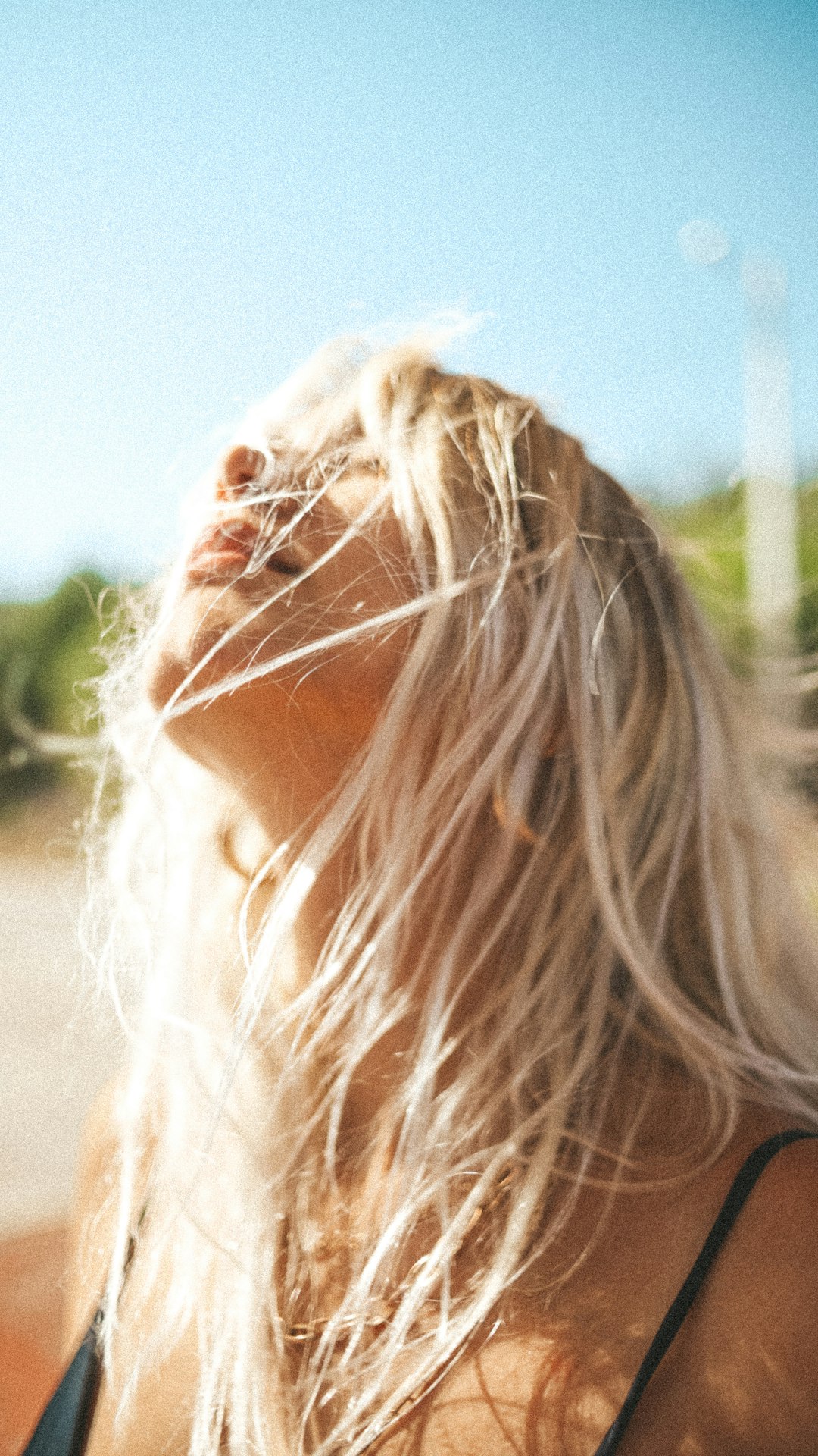 woman with blonde hair looking down