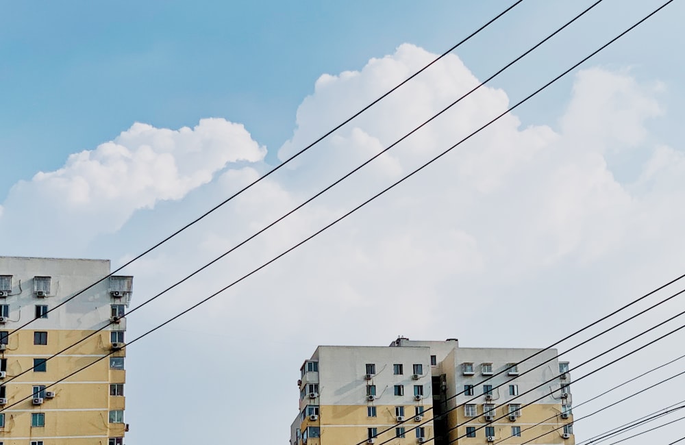 white concrete building under white clouds during daytime