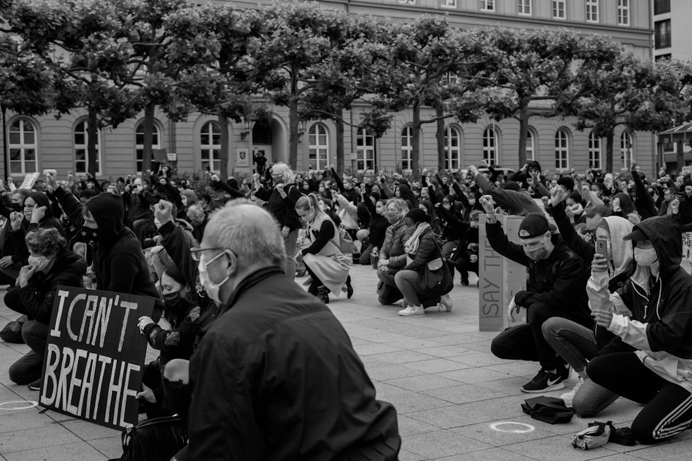 grayscale photo of people sitting on chairs