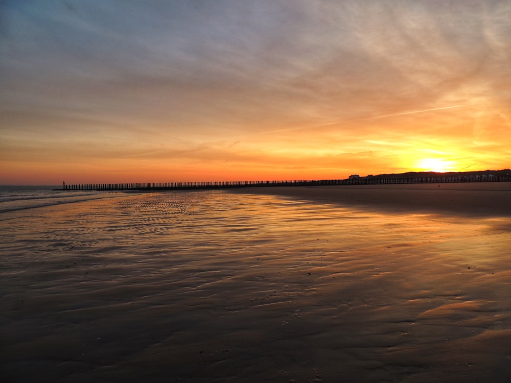 body of water during sunset