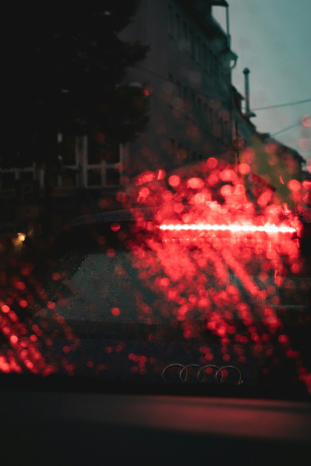 city buildings with red lights during night time