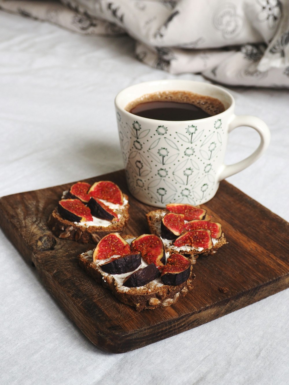 white ceramic mug on brown wooden chopping board