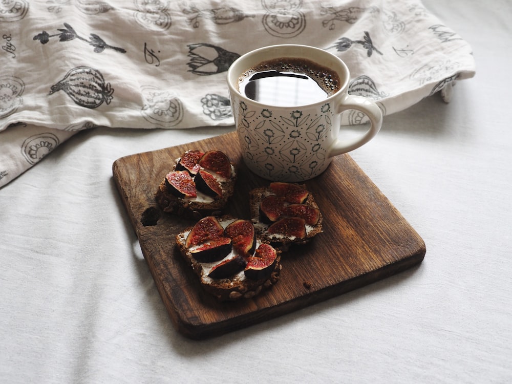 brown wooden tray with cookies and white ceramic mug