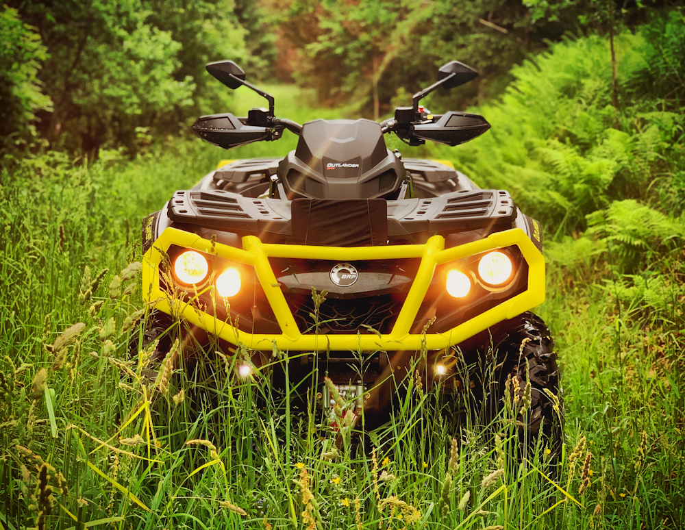 yellow and black ride on toy car on green grass during daytime