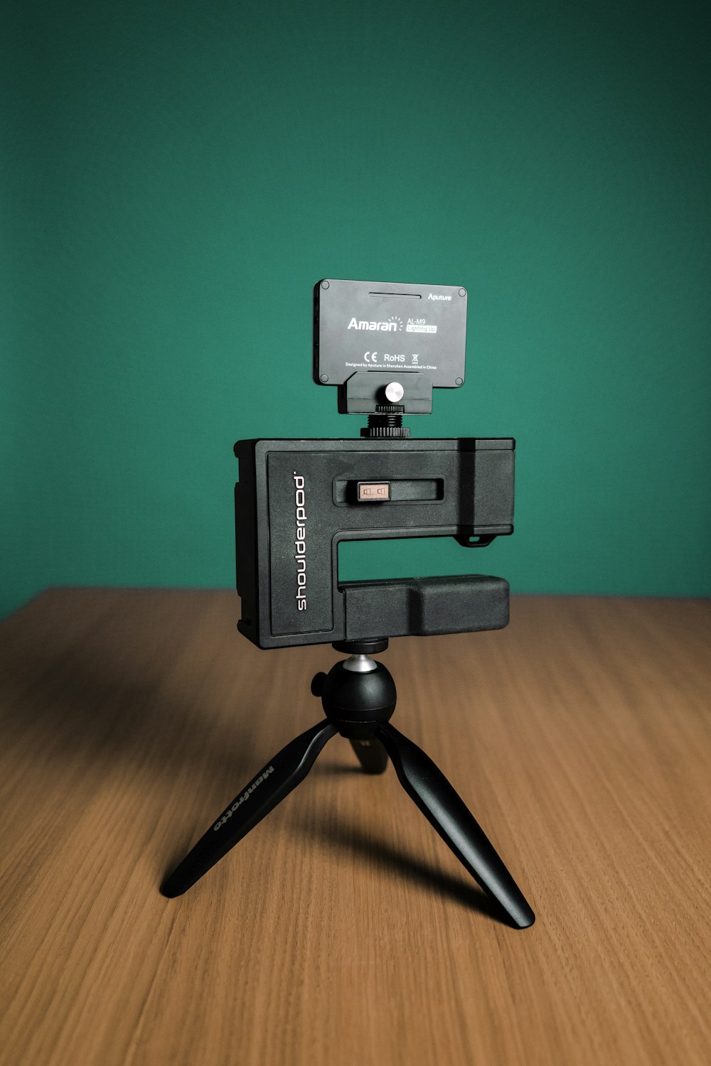 black and gray camera on brown wooden table