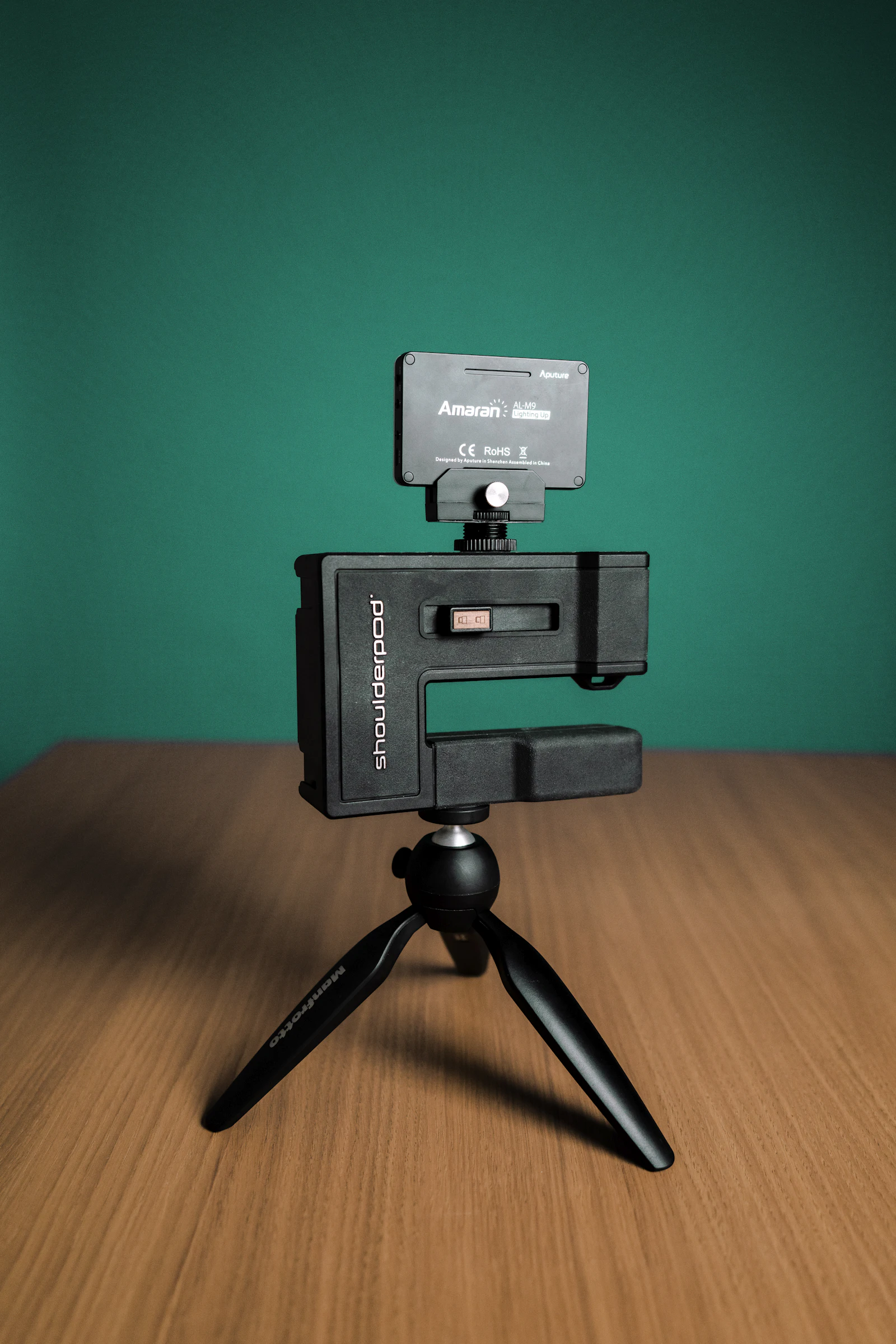 A black and grey compact camera on a wooden table