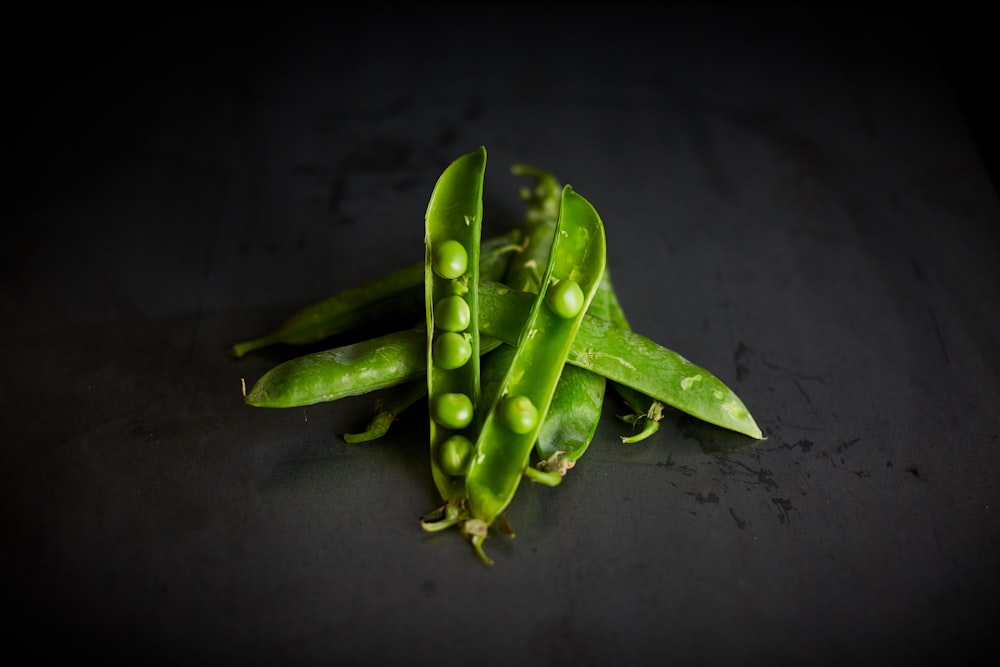 green peas on black surface