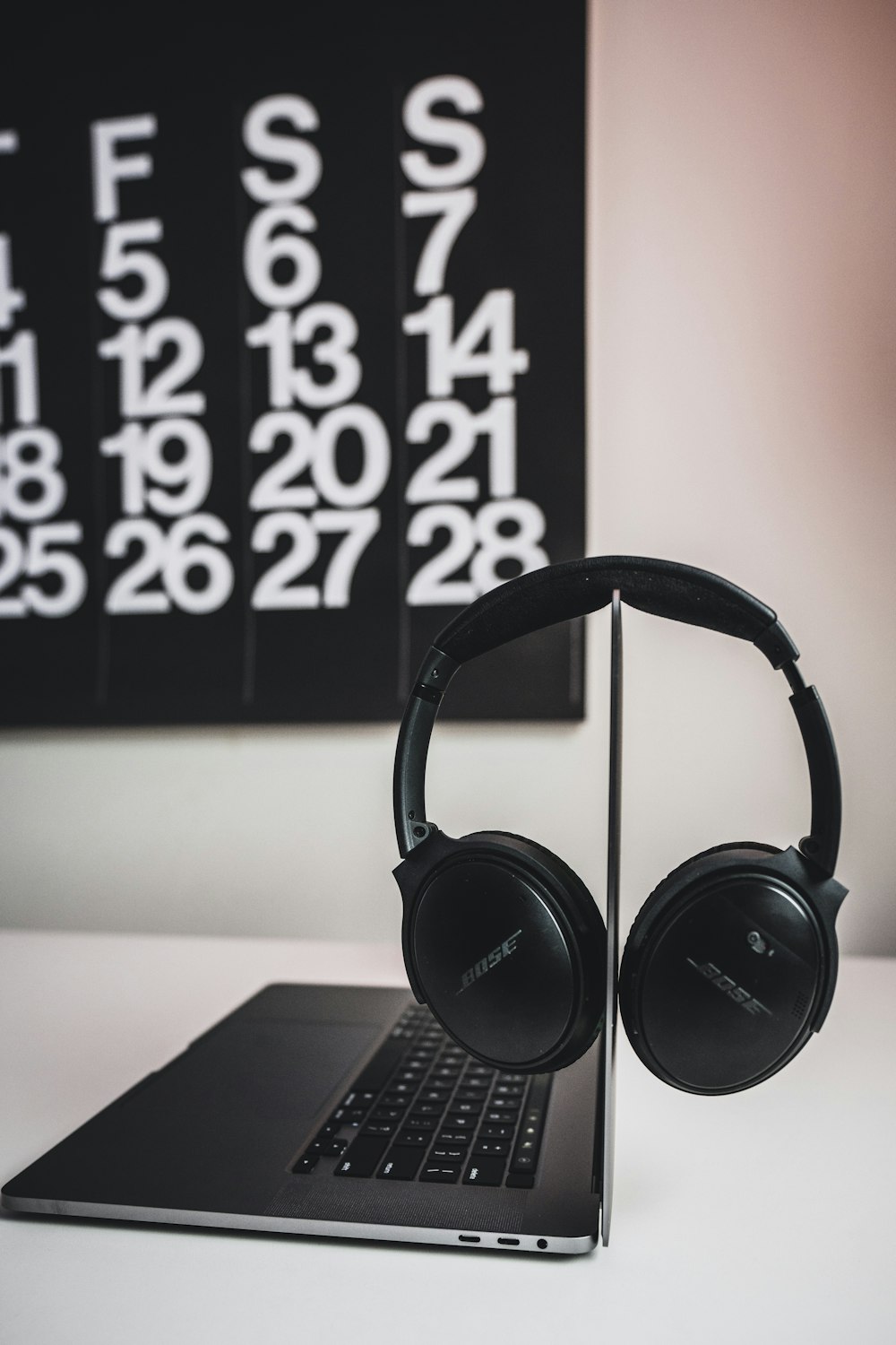 black headphones on black laptop computer