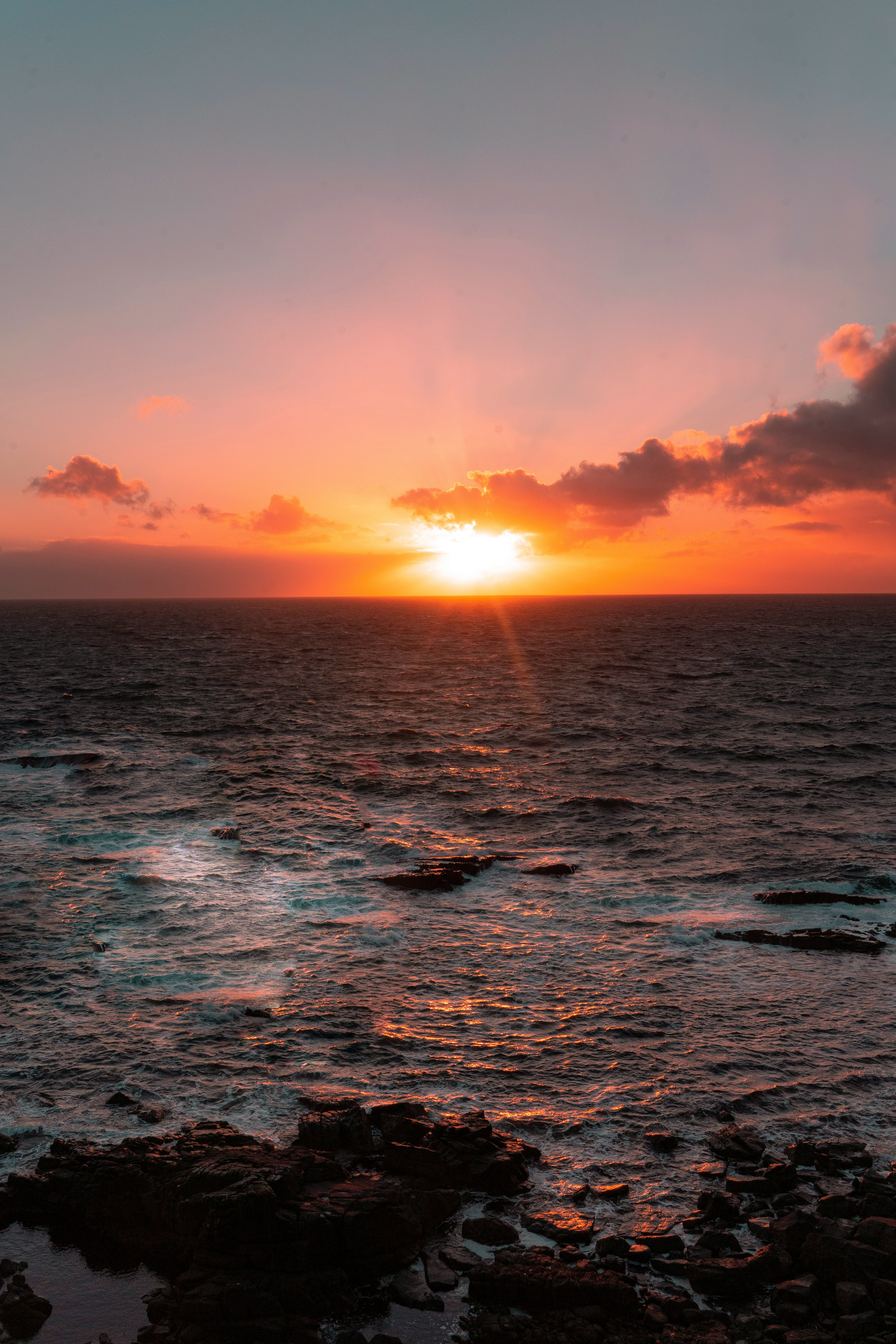 body of water during sunset