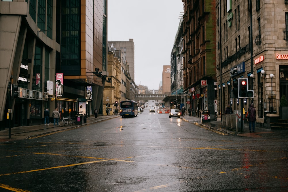 cars on road between buildings during daytime