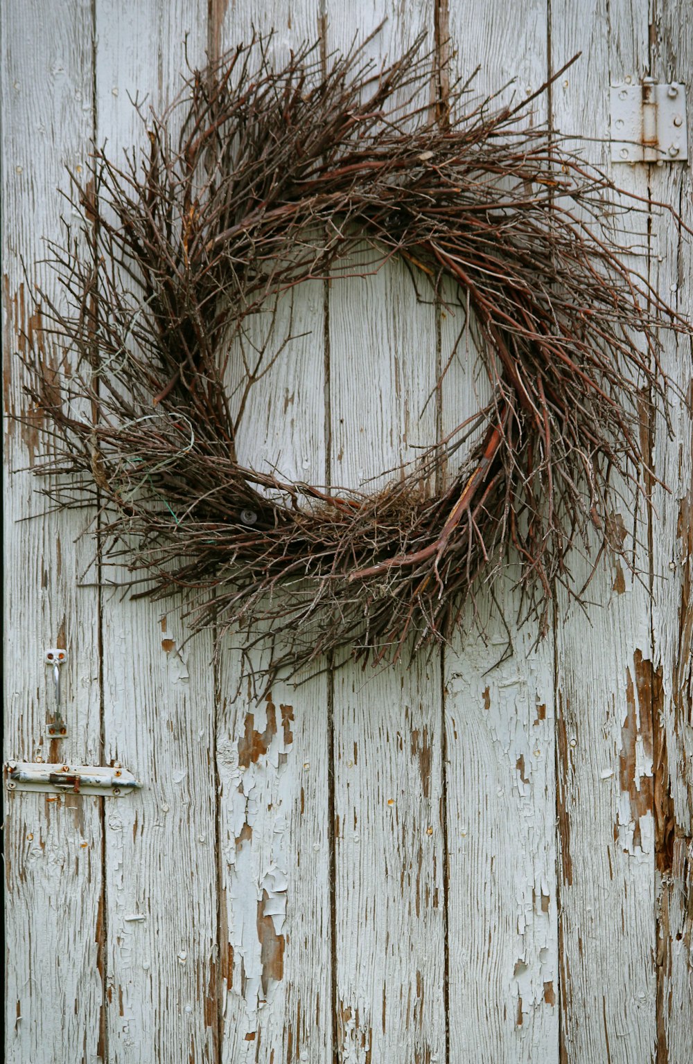 brown dried grass on white wooden door