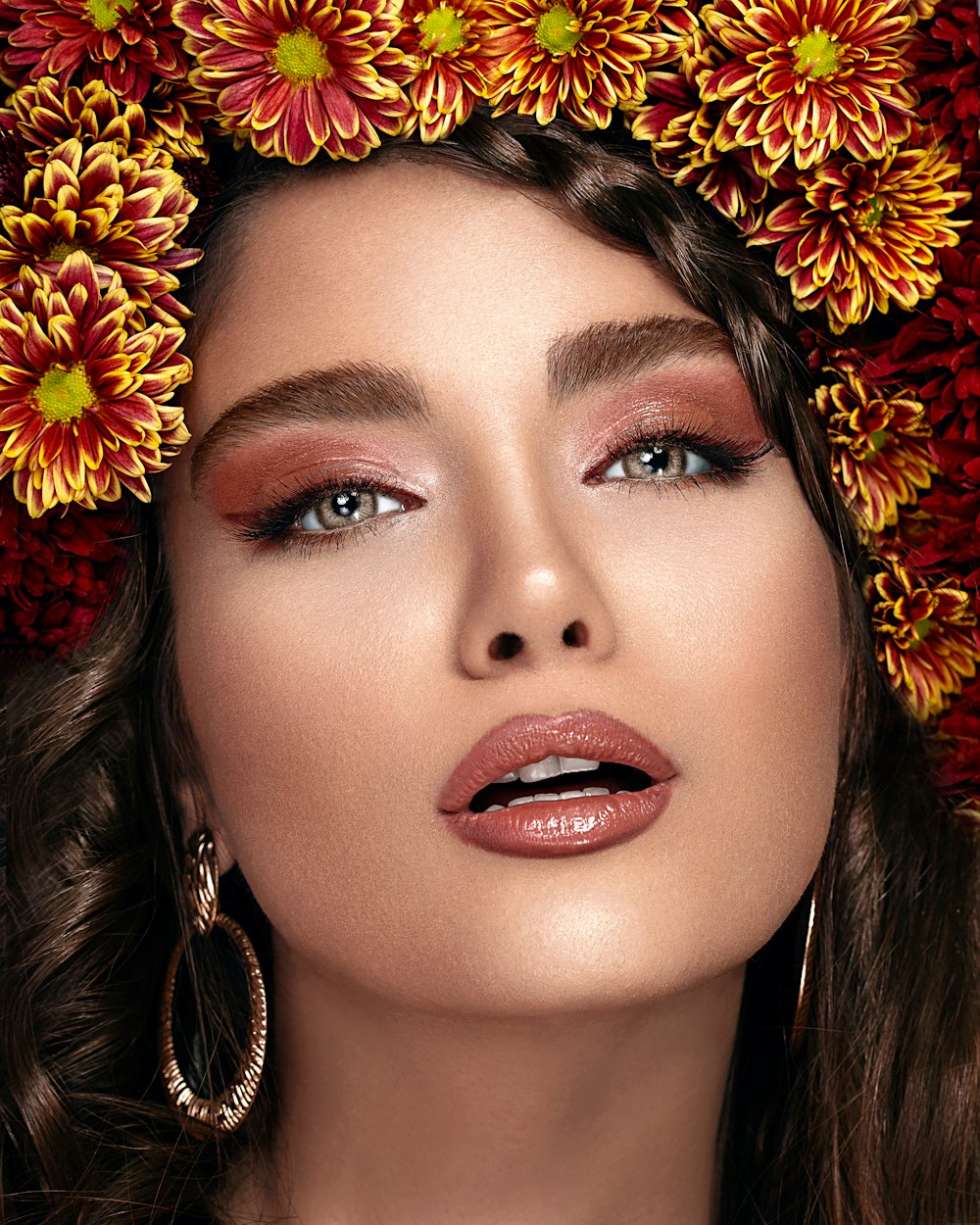 woman with red lipstick and yellow flower on her head