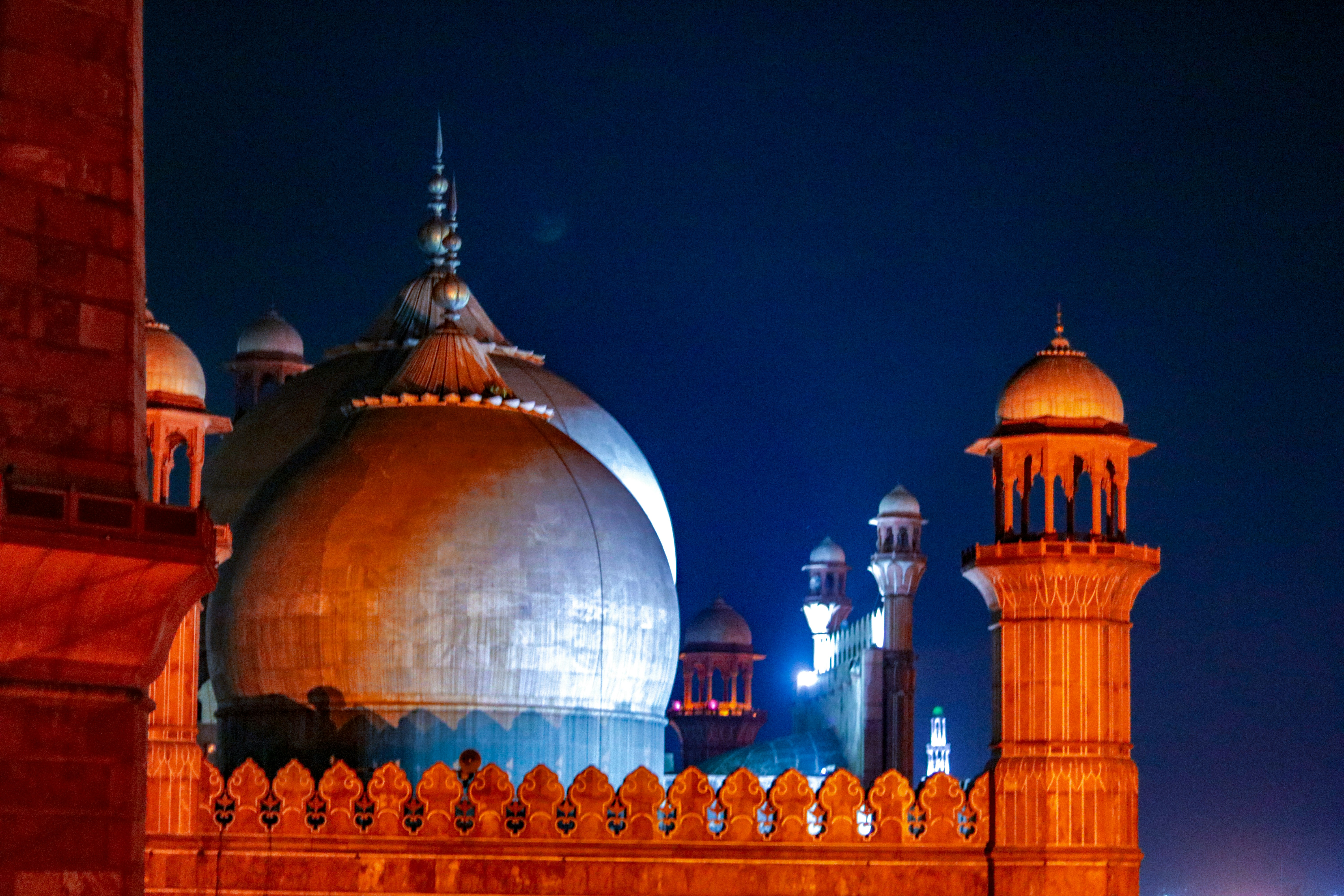 A very tall building with a clock tower at night
