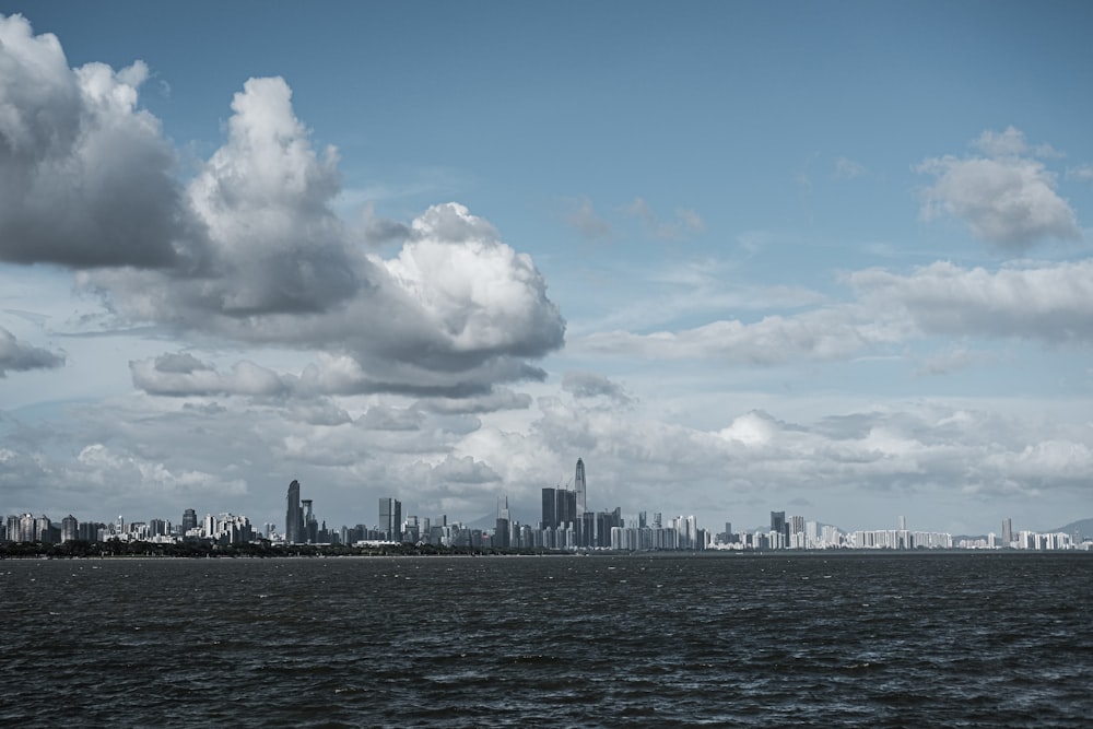 city skyline under white clouds and blue sky during daytime