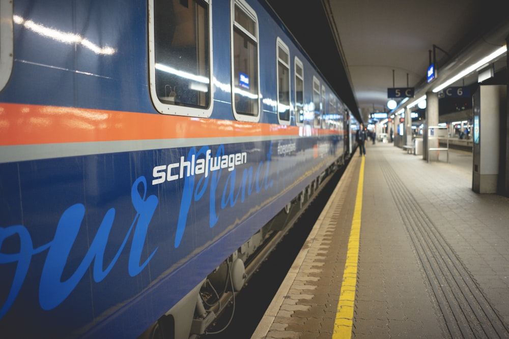 blue and white train on train station