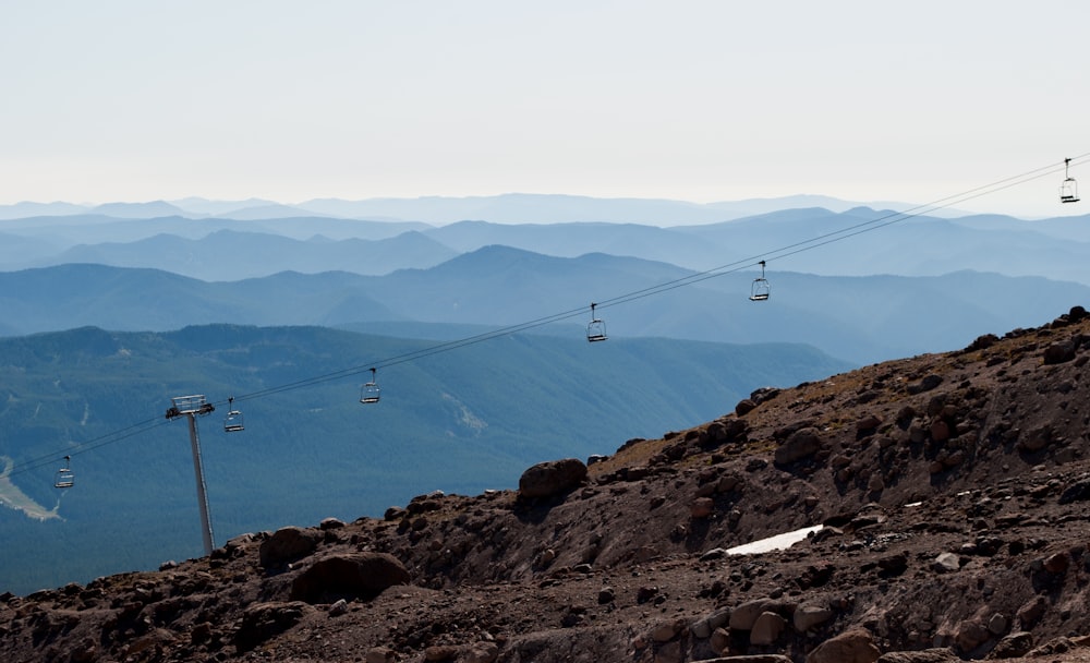 cable cars over the mountains during daytime