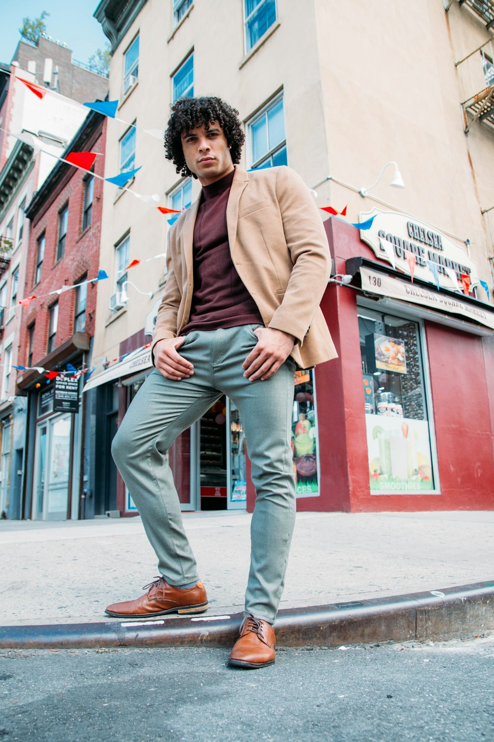 woman in brown coat and gray pants standing on gray concrete floor during daytime