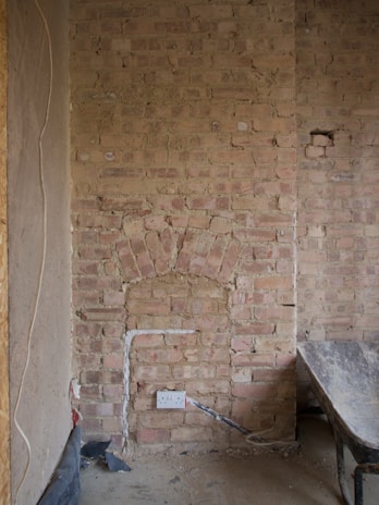 A wall mid-renovation showing clean masonry work and precise electrical installations.
