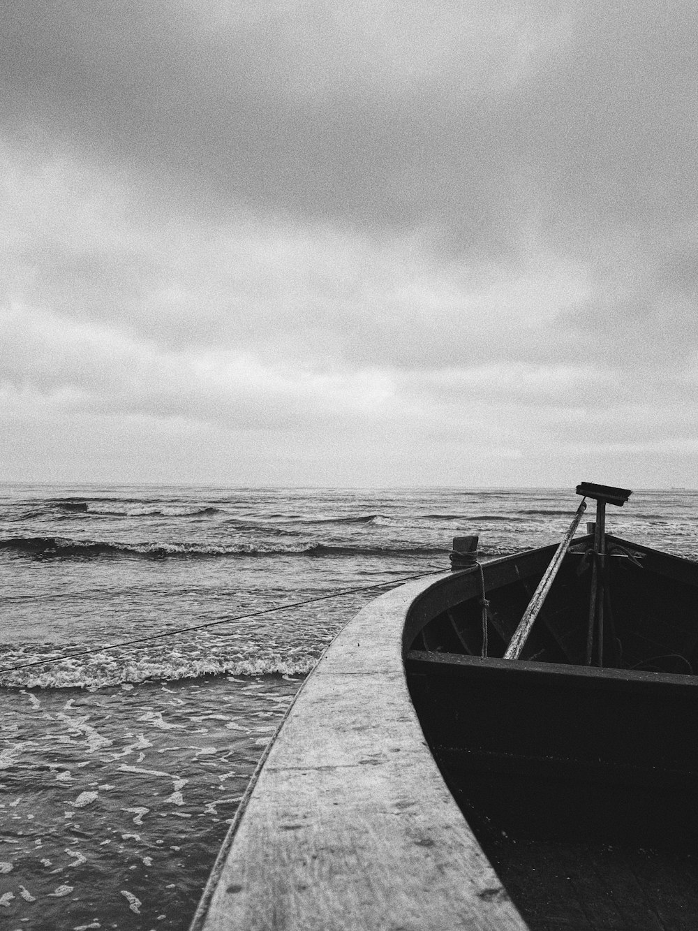 grayscale photo of boat on sea