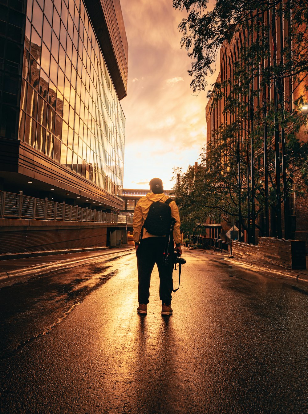 man in black jacket and black pants walking on street during daytime