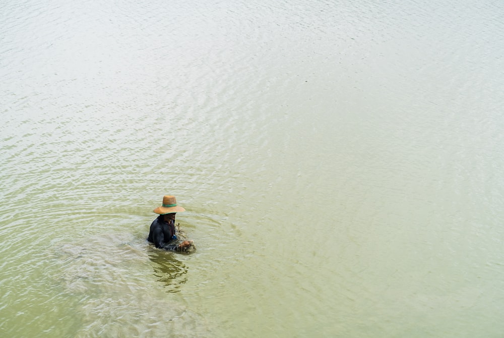 person in black shirt and blue denim jeans on water during daytime