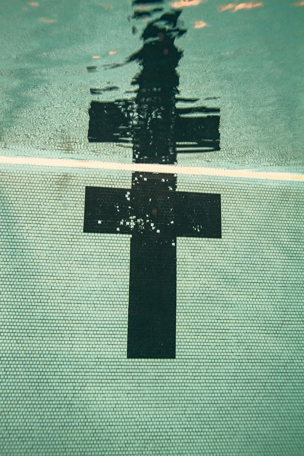 black cross on gray surface