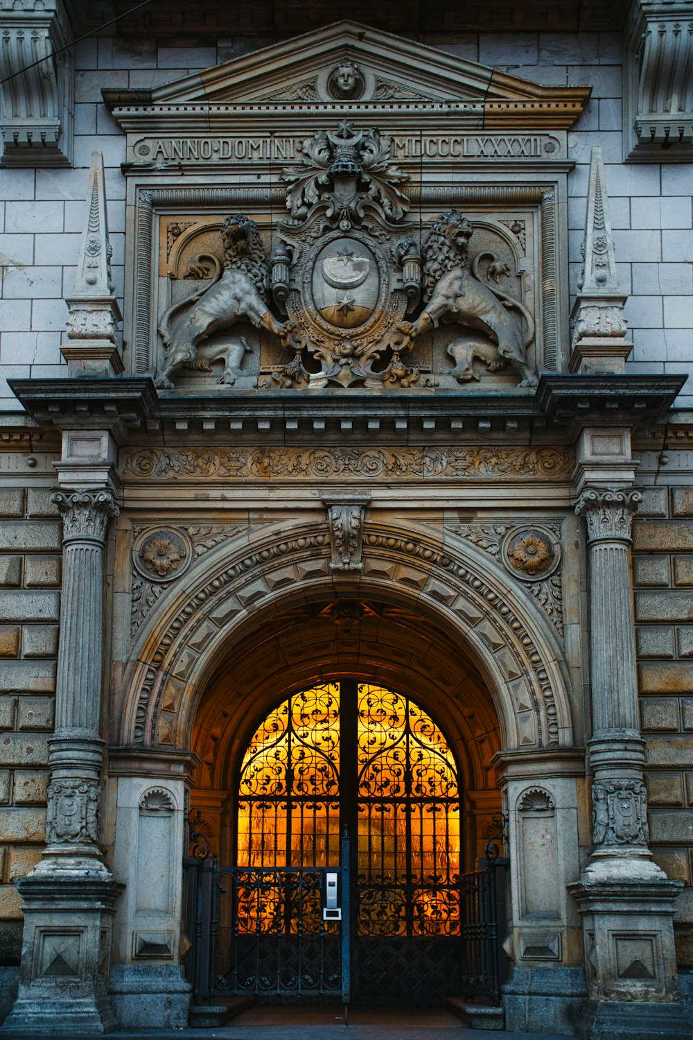 black metal gate on white concrete building